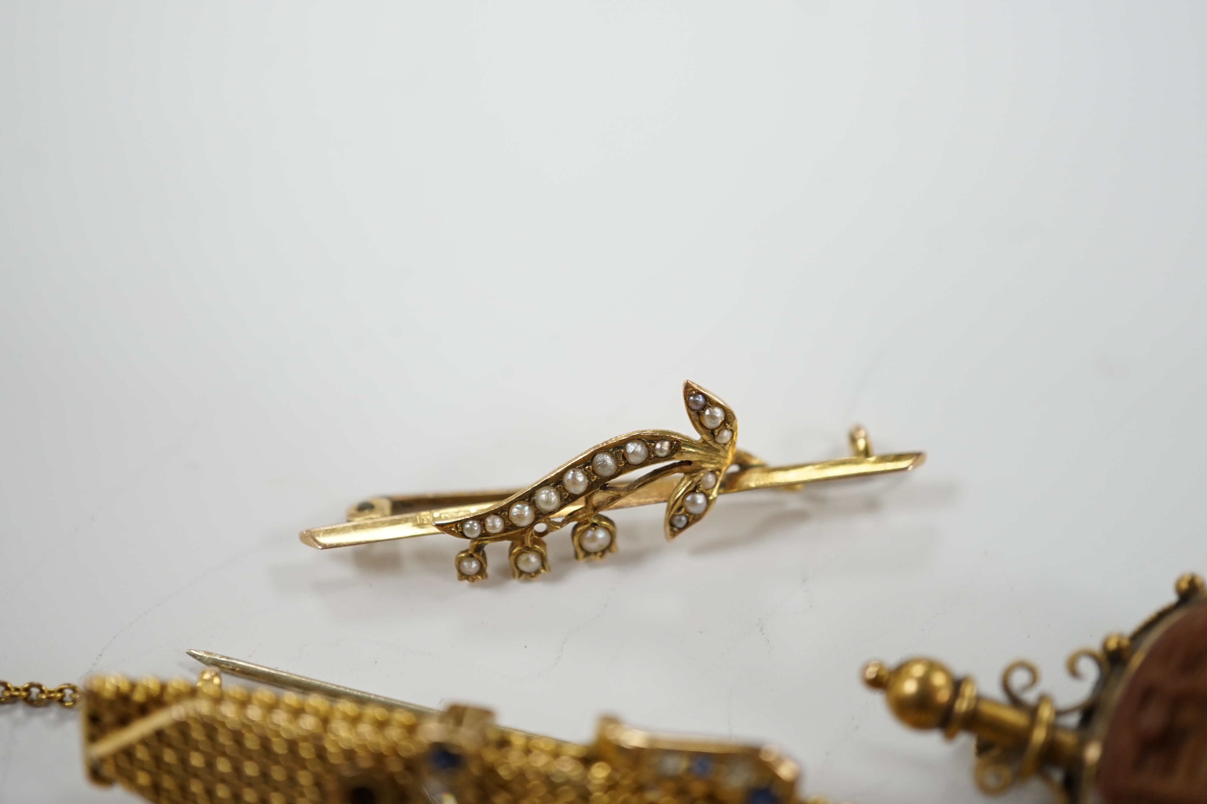 Four assorted yellow metal and gem set bar brooches including sapphire and diamond chip set buckle brooch, 51mm and two other yellow metal brooches, one set with diamond and split pearl